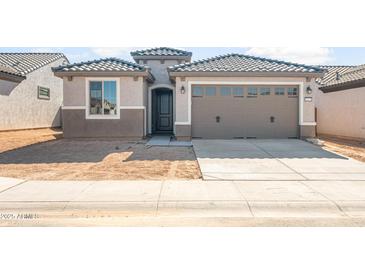 Charming single-story home with neutral tones, a two-car garage, and a tile roof at 21352 N 271St Dr, Buckeye, AZ 85396