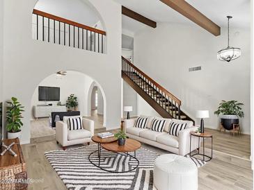 Bright living room featuring vaulted ceilings, wood beams, and an open floor plan at 2619 S Los Altos --, Mesa, AZ 85202
