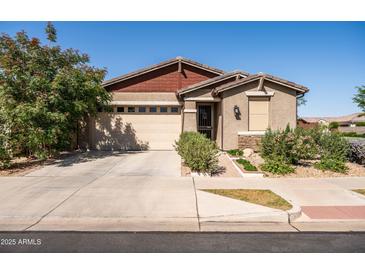 Charming single-story home with a two-car garage and well-maintained landscaping at 5616 S Caisson Way, Mesa, AZ 85212