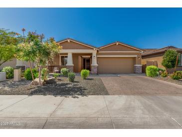 Charming single-story home with a two-car garage and nicely landscaped front yard at 12143 W Marguerite Ave, Avondale, AZ 85323