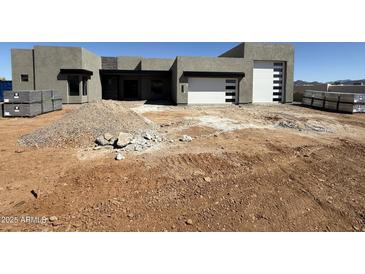 Contemporary home featuring a clean-lined design with a white sectional garage door on a sunny day at 1250 E Smokehouse Trl, Phoenix, AZ 85085