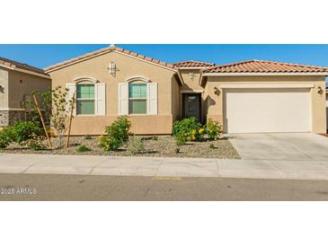 Charming single-story home with neutral stucco, tiled roof, two-car garage, and low-maintenance desert landscaping at 13618 W Phacelia Ln, Peoria, AZ 85383