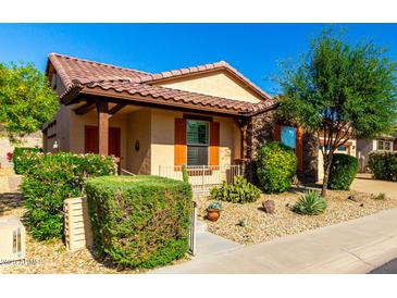 Charming single-story home with Southwestern architectural details, desert landscaping and a welcoming front porch at 17139 S 174Th Dr, Goodyear, AZ 85338