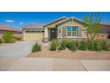Charming single-story home with a neutral exterior, low maintenance landscaping, and a two-car garage at 2464 N Morrison Ave, Casa Grande, AZ 85122