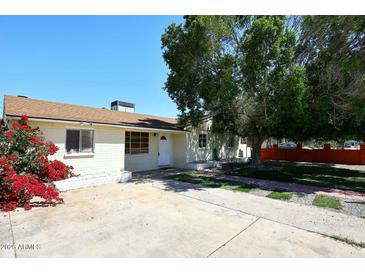 Inviting single-story home with a well-maintained front yard and mature shade tree at 2614 W Greenway Rd, Tempe, AZ 85282