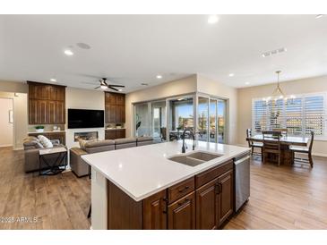 Open-concept kitchen with a spacious island, modern appliances, and seamless access to the outdoor patio at 32237 N 133Rd Dr, Peoria, AZ 85383