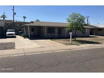 Charming single-story home with mature tree and covered entry at 3419 W Glenn Dr, Phoenix, AZ 85051