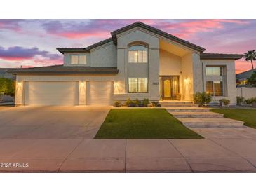 Elegant two-story home with a well-manicured lawn, three-car garage, and a stylish front entrance at 3623 S Agave Way, Chandler, AZ 85248
