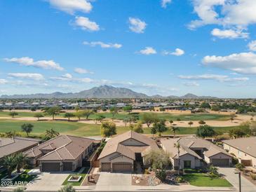 Beautiful aerial view of a community with golf course and mountain backdrop on a sunny day, Arizona real estate at 3933 E Meadowview Dr, Gilbert, AZ 85298