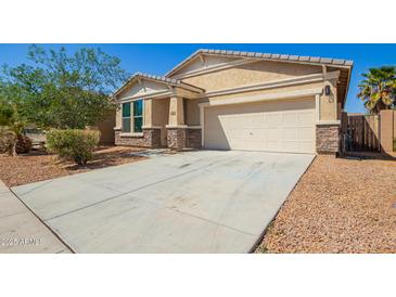Charming single-Gathering home with a well-manicured lawn, desert landscaping, and attached two-car garage at 40800 W Rio Grande Dr, Maricopa, AZ 85138