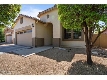 Inviting single-Gathering home featuring a two-car garage and desert landscaping at 4617 W Cottontail Rd, Phoenix, AZ 85086
