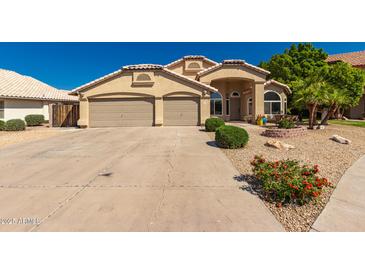 Inviting single Gathering home with a three car garage and low maintenance desert landscaping at 632 W Natal Cir, Mesa, AZ 85210