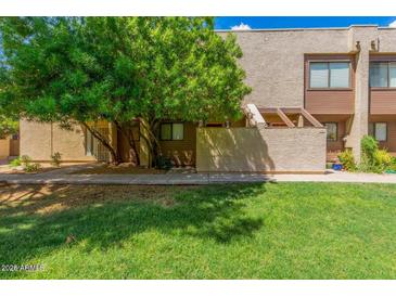 Inviting townhome featuring mature trees and a well-manicured lawn at 811 W 13Th St, Tempe, AZ 85281