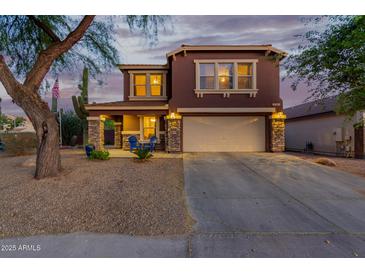 Charming two-story home with a spacious driveway and a well-maintained front yard with desert landscaping at 10561 E Plata Ave, Mesa, AZ 85212