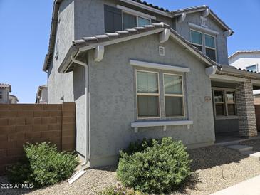 Charming two-story home featuring low-maintenance landscaping and gray stucco exterior at 14224 W Hackamore Dr, Surprise, AZ 85387