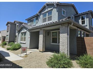 Charming two-story home with a welcoming porch and beautifully landscaped front yard in a desirable neighborhood at 14224 W Hackamore Dr, Surprise, AZ 85387