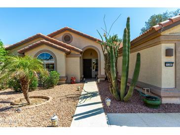 Charming single-story home featuring desert landscaping, a walkway, and a welcoming entrance at 15395 W Pinchot Ct, Goodyear, AZ 85395