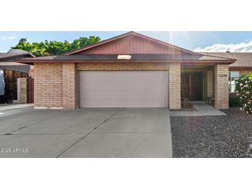 Charming brick home featuring a two-car garage and well-maintained front yard at 16638 N 46Th Ln, Glendale, AZ 85306