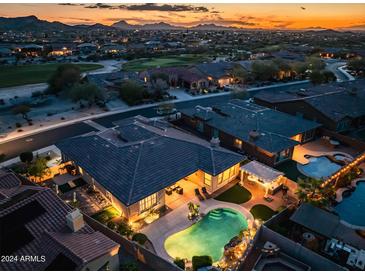 Stunning aerial view of the property with a pool and outdoor kitchen at sunset at 18126 W Ocotillo Ave, Goodyear, AZ 85338
