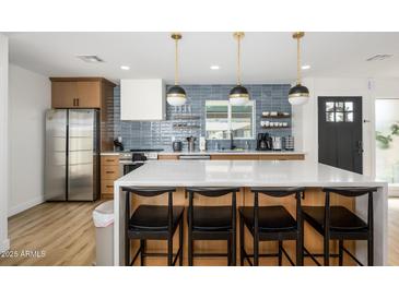 Modern kitchen featuring stainless steel appliances, white countertops, and stylish pendant lighting at 2044 N 71St St, Scottsdale, AZ 85257
