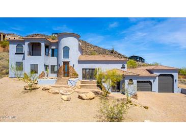 Stunning two-story home with a circular tower, tile roof, and a multi-car garage set against a mountain backdrop at 2110 E Kerry Ln, Phoenix, AZ 85024