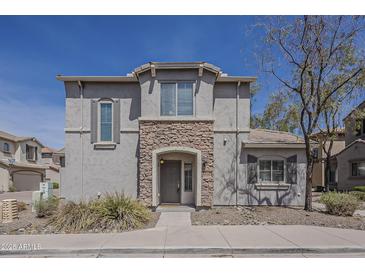Charming two-story home featuring stone accents around the front entry and shuttered windows at 2144 W Barwick Dr, Phoenix, AZ 85085