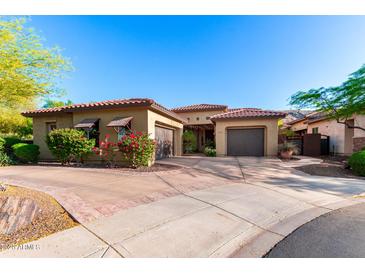 Charming single-story home with a tile roof, desert landscaping and circular driveway at 2335 E Allen St, Phoenix, AZ 85042