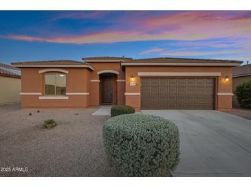 Charming single-story home featuring a two-car garage, low maintenance landscape and a neutral colored exterior at 42335 W Waterfall Way, Maricopa, AZ 85138
