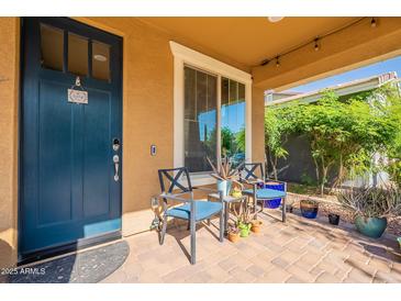 Inviting covered porch featuring a seating area, neutral walls, and beautiful brick flooring at 5012 S Girard St, Gilbert, AZ 85298