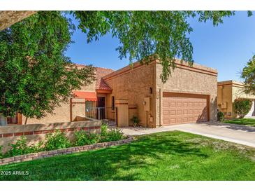 Charming single-story home with a well-maintained front yard and two-car garage at 563 N Spanish Springs Dr, Chandler, AZ 85226