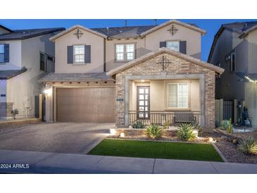 Charming two-story home featuring a brick facade, well-manicured landscaping, and a two-car garage at 634 E Deer Creek Rd, Phoenix, AZ 85048