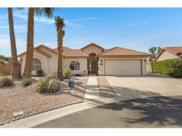 Charming single-story home featuring a tile roof, desert landscaping, and an attached two-car garage at 6341 S Cypress Point Dr, Chandler, AZ 85249