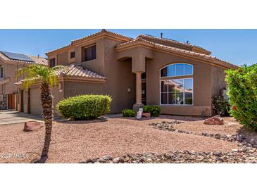Charming two-story home featuring a well-maintained yard and neutral-toned exterior at 7103 E Medina Ave, Mesa, AZ 85209