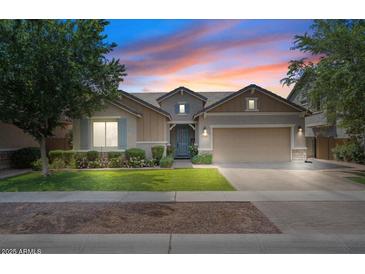 Charming single-story home with a well-manicured lawn and a two-car garage, showcasing inviting curb appeal at 7149 E Plata Ave, Mesa, AZ 85212