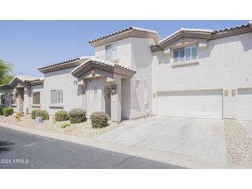 Inviting two-story home with stucco siding, well-kept landscaping, and an attached two-car garage at 7978 W Zoe Ella Way, Peoria, AZ 85382