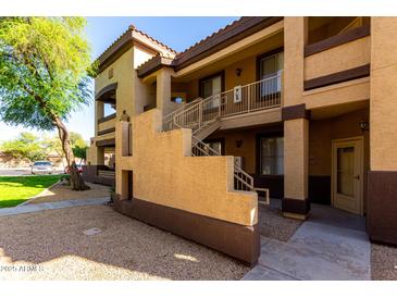 Inviting multi-story condo with well-maintained landscaping and convenient staircase access at 10136 E Southern Ave # 2064, Mesa, AZ 85209