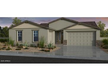 Attractive single-story home featuring a two-car garage and well-maintained landscaping at 17110 W Hackamore Dr, Surprise, AZ 85387