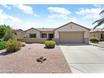 Charming single-story home featuring a well-maintained yard and a two-car garage at 20473 N Desert Sage Ln, Surprise, AZ 85374