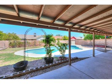 Inviting pool area with a covered patio, perfect for outdoor relaxation and entertainment at 2322 E Dolphin Ave, Mesa, AZ 85204