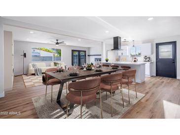 Bright dining room features stylish table, seating, and easy access to the kitchen and living room at 3231 W Willow Ave, Phoenix, AZ 85029