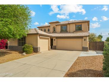 Charming two-story home with a three car garage and beautiful desert landscaping at 3370 E Flamingo Ct, Gilbert, AZ 85297