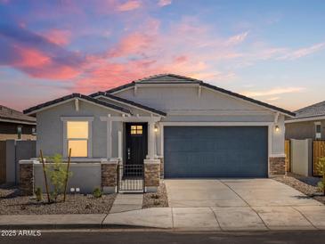 Beautiful one-story home featuring a two-car garage, neutral color palette, and landscaped front yard at 37084 W Prado St, Maricopa, AZ 85138