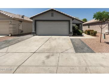 Charming single-story home featuring a two-car garage and well-maintained landscaping at 4232 N 112Th Ln, Phoenix, AZ 85037
