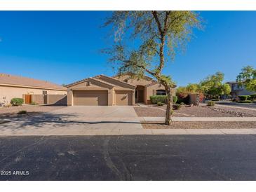 Charming home featuring a well-manicured front yard, desert landscaping, and a spacious three-car garage at 4356 E Carriage Way, Gilbert, AZ 85297
