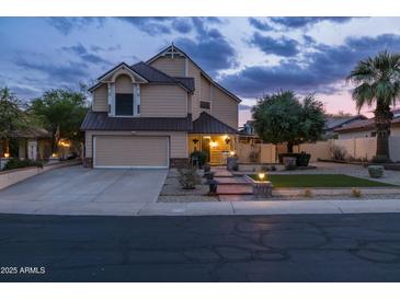Charming two-story home featuring a well-manicured lawn and inviting curb appeal at twilight at 4715 E Carmen St, Phoenix, AZ 85044