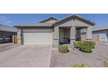 Charming single-story home featuring a neutral color palette, manicured landscaping, and a two-car garage at 5048 N 84Th Dr, Glendale, AZ 85305