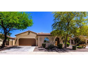 Charming single-story home featuring a well-manicured front yard and attached two-car garage at 7159 S Dodane Ct, Gilbert, AZ 85298