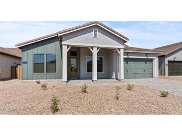 Charming single-story home featuring a stylish covered entry, two-car garage, and desert landscaping at 42064 N Golden Trl, San Tan Valley, AZ 85140