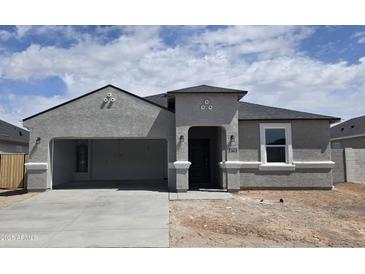 Charming single-story home with a stucco exterior, arched entry, and attached carport at 5712 E Axle Ln, San Tan Valley, AZ 85140