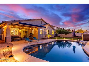 Beautiful backyard featuring a private pool, covered patio, and lounge chairs at 196 W Yellow Wood Ave, San Tan Valley, AZ 85140